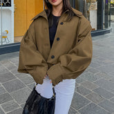 Person wearing a brown coat on a city street